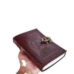 Vintage embossed leather journal with Celtic-inspired border, pentagram design, and antique-style metal clasp